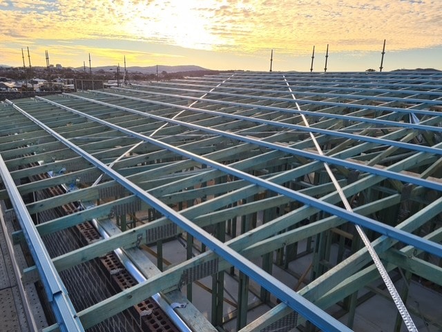 Commercial roof framing at sunset